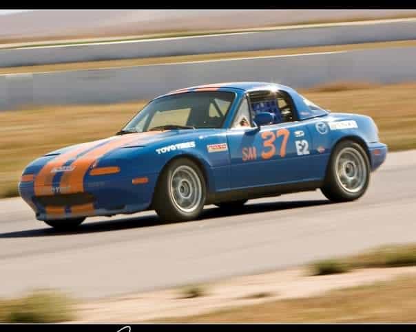 Blue car with orange accents on a racetrack